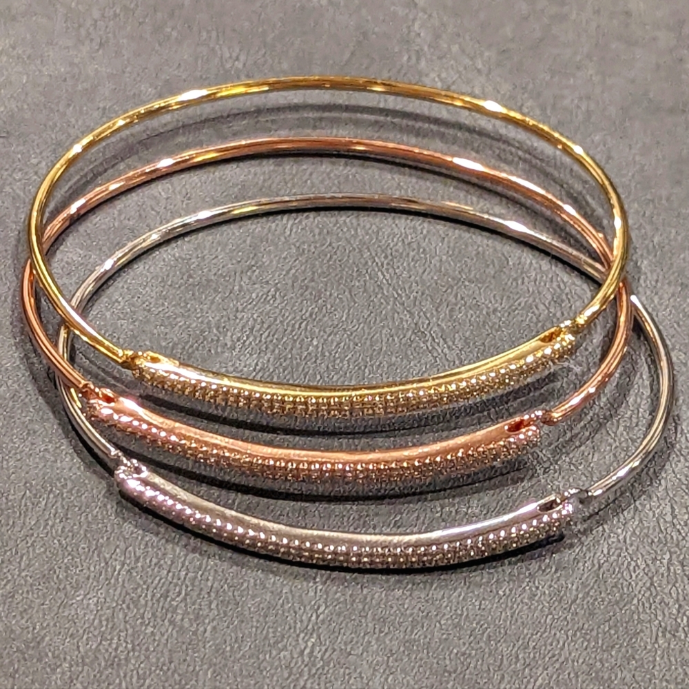 Set of 3 cubic zirconia gold, rose gold, and rhodium plated bangle.